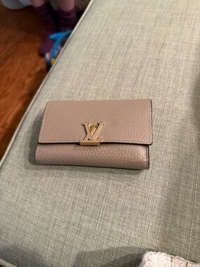 Louis Vuitton Pebbled Leather Compact Wallet in Taupe with Gold LV Hardware
COA